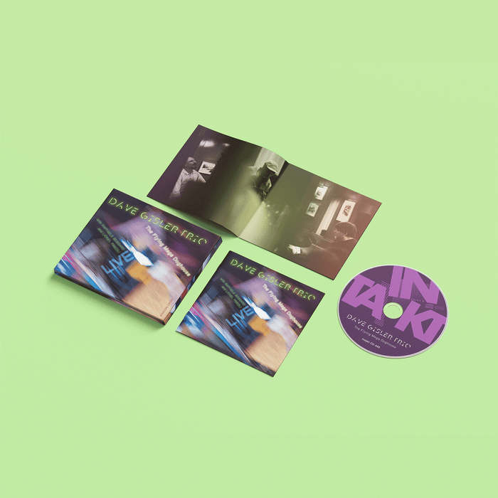Music album with three CDs and a purple disc on a green background
