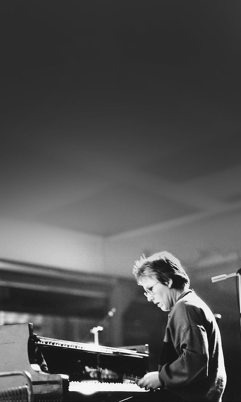 Black and white photograph of Irène Schweizer playing a grand piano at Volkshaus Zurich in 1986.
